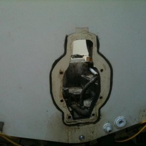 Someone tried to fix the leak with caulk from the wrong side. The two holes to the right are the live well hoses. the pump one had silicone on it and 