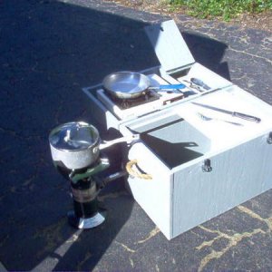 Galley opened up. Small saute grill on top with a compartment to the immediate right to hold knifes, spatula, etc. Coleman stove secured on left side.