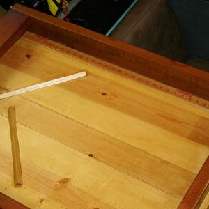 wood strips are to (hopefully) block pliars/knife from exiting when I forget they are there.  Also glued a yard stick to the port inside to measure th