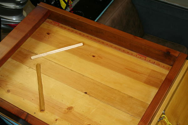 wood strips are to (hopefully) block pliars/knife from exiting when I forget they are there.  Also glued a yard stick to the port inside to measure th